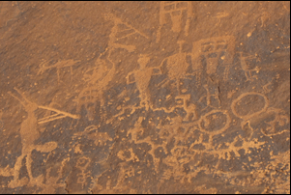 Kokopelli and other ancient puebloan (Anasazi) figures carved into canyon walls